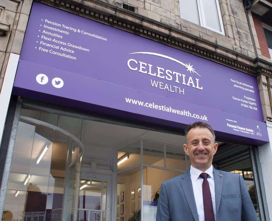 A man smiling in front of a building with a big purple overhead sign reading "Celestial Wealth."