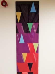 A Perspex panel, black, purple, and red.