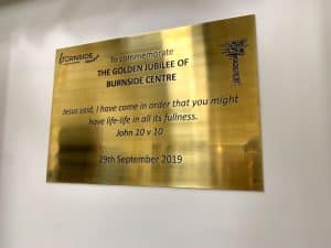 A brass plaque commemorating the Golden Jubilee of Burnside Centre.