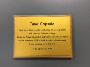 A yellow aluminium sign titled "Time Capsule".