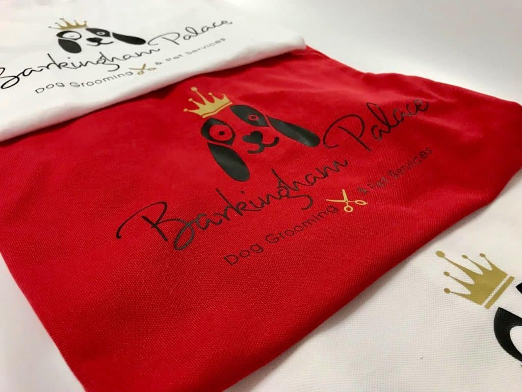 Two t-shirts, one white and one red, with the Barkingham Palace logo.