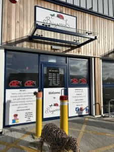 A shop door with signage welcoming you to Bugweed's.