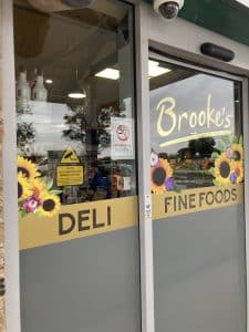 A window for Brooke's showing decals that say "Deli" and "Fine Foods."