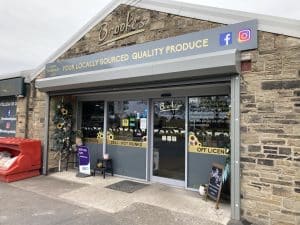 a pale brick exterior shopfront for Brooke's Farm Shop.