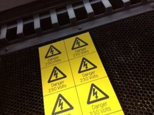 Six yellow signs with the electricity danger symbol.