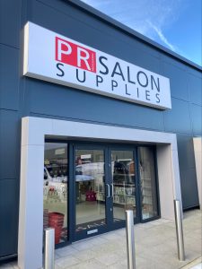a shopfront with a sign saying PR Salon Supplies.