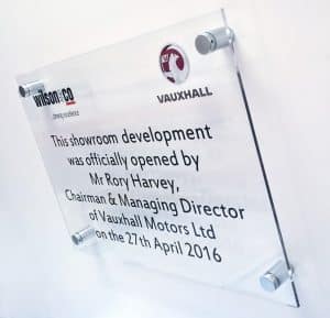 A clear Perspex sign announcing "this showroom development was officially opened by Mr Rory Harvey."