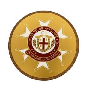 A round sigil with a shield that says "Proud to be affiliated to the World Master Chefs Society."